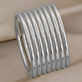 Polished silver 3mm stainless steel bangles layered on champagne silk background - Large Stack Style / Steel