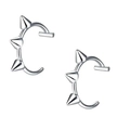 Macro view of silver punk stainless steel ear clips featuring sharp conical rivets - Steel