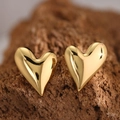 Macro view of gold 304 stainless steel heart earrings with polished mirror finish - Irregular 3D Heart (EH098)