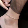 Detailed close-up of a silver titanium steel anklet with shimmering twisted chain design - 21.5cm / Silver