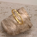 Detail of gold honeycomb bangle with sparkling zircons set against a natural stone background - Honeycomb Hexagon Style (SZ002)