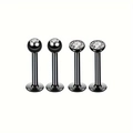 Détail macro de quatre piercings de lèvre noirs en acier avec pierres de zircon - 1.2x6x3mm / Style Noir