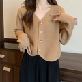 Women's chic camel V-neck knitted cardigan with amber buttons in a cozy home setting - One Size / Light Khaki
