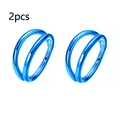 Detail view of two pieces of blue plated stainless steel double hoop nose rings on white background - Blue