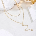 Collier double rang en acier inoxydable doré avec pendentifs trèfles et zircons blancs éclatants - Collier Trèfle à Quatre Feuilles