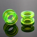 Detailed view of neon green acrylic ear gauges with smooth polished surface on reflective black - US 2 / Green