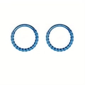 Pair of bright blue twisted stainless steel nose rings with polished braided texture - Size XS / Blue