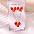Close-up of red enamel bow necklace and stud earrings set on a stainless steel card - Bowknot Style (TZ255-Red)