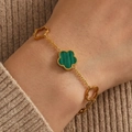 Elegante bracciale in oro con malachite verde e motivi floreali traforati indossato al polso - Verde