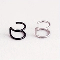 Close-up of double spiral stainless steel ear cuffs in matte black and silver finishes - Black And Steel