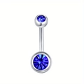 Detail of silver stainless steel navel ring with dark blue bezel-set rhinestones - Sapphire Blue