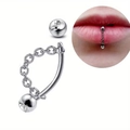 Macro view of stainless steel curved barbell lip ring with rhinestone and chain detail - Inlay / 8mm