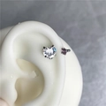Macro detail of heart-shaped zircon and purple crystal studs on a silicone ear model - Heart White And Pink (Steel Color Bar)