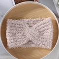 Pink plush cross knot knitted headband with fuzzy texture in a cozy setting - Pink