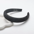Padded matte black headband with embossed heart pattern and handmade inner label - Black