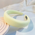 Detail of yellow padded sponge headband with handmade label on white textured cloth - Bright Yellow