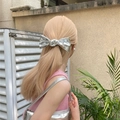 Shiny silver bow hair clip in mirror faux leather finish for a high-top ponytail look - Silver Bow Spring Hair Clip