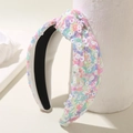 Colorful sequin mesh headband with twist knot design on a white fabric base - Colorful