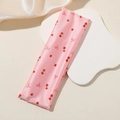 Pink satin headband detail with printed red cherries and tiny bows on silk texture - Cherry