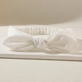 White ribbed knit elastic headband with a soft bow design for women's hair care - Ivory