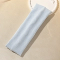 Light blue elastic knitted headband for women, soft sports hairband in a flat-lay view - Blue Gray