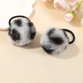 Pair of fluffy black and white spotted leopard faux fur scrunchies on a cream tray - Silver