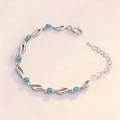 Elegant wavy silver bracelet with six round blue crystals and adjustable lobster clasp - Blue