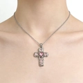 Silver cross pendant necklace with a pink heart gemstone and enamel, worn by a model - Necklace / Pink Necklace