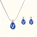 Detailed view of silver necklace and earrings set with blue teardrop crystals - Sapphire Blue