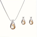 Detail view of silver drop necklace and earrings set with champagne crystals on white base - Champagne