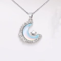 Detailed close-up of crescent moon necklace pendant with blue opal and silver star detail - Moon Star Pendant / Blue Necklace