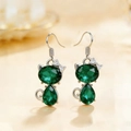 Silver cat earrings set with heart-shaped green emerald crystals and bow detail - Earrings / Green