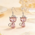 Pink heart-shaped crystal cat earrings in silver setting with sparkling rhinestone bow - Earrings / Pink