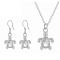 Macro detail of silver turtle jewelry set with faceted clear crystals and pavé accents - White