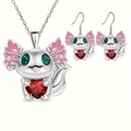 Detail of axolotl jewelry set featuring heart-shaped red gems and green stone eyes - Set