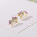 Detailed close-up of unicorn stud earrings with colorful crystals and gold plating - Gold Earrings