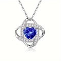 Macro detail of heart necklace featuring deep blue heart stone and pavé crystal setting - September - Dark Blue