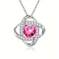 Detail of silver heart pendant with pink gemstone and white diamonds on white background - July Rose Red
