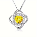 Detail of silver heart pendant with yellow gemstone and sparkling white crystals - November-Yellow