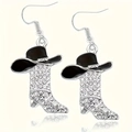 Macro shot of western style cowboy hat and rhinestone encrusted boots earrings - Black
