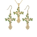 Close-up of golden Celtic cross necklace and earrings set with green enamel leaves - Necklace & Earrings / Gold