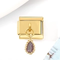 Macro view of a gold Italian charm featuring a purple faceted teardrop gemstone pendant - Purple Zirconia Style / Purple Zircon Navette Gold Charm