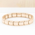 Detailed macro shot of modular gold-plated stainless steel Italian charms link with letter A - Letter A