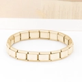Macro shot of gold Italian charm bracelet links featuring engraved letter B motifs - Letter B