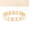 Macro shot of gold stainless steel modular Italian charms bracelet with letter C links - Letter C