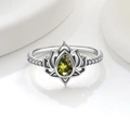 Detailed macro view of S925 sterling silver lotus ring with green zircon and side stones - US 5 / Platinum (Olive Green Zirconia)