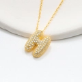 Close-up of golden puffy letter H pendant with shimmering zircon pavé stones on a chain - 925 Silver / Gold (Letter H)