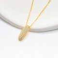 Macro shot of gold-plated capsule pendant necklace featuring sparkling white zircon stones - 925 Silver / Gold (Letter I)