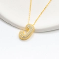 Detailed close-up of golden bubble letter J pendant with shimmering zircon pavé stones - 925 Silver / Gold (Initial J)