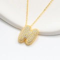 Detailed macro view of S925 silver bubble letter M pendant with sparkling cubic zirconia stones - 925 Silver / Gold (Initial N)